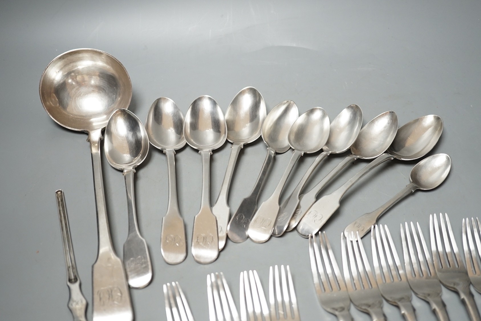 Twenty three items of continental white metal fiddle pattern flatware, stamped GH, including a soup ladle and marrow scoop